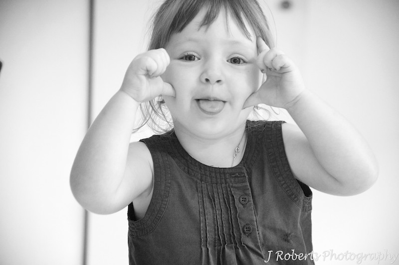 B&W of little girl making faces - family portrait photography sydney
